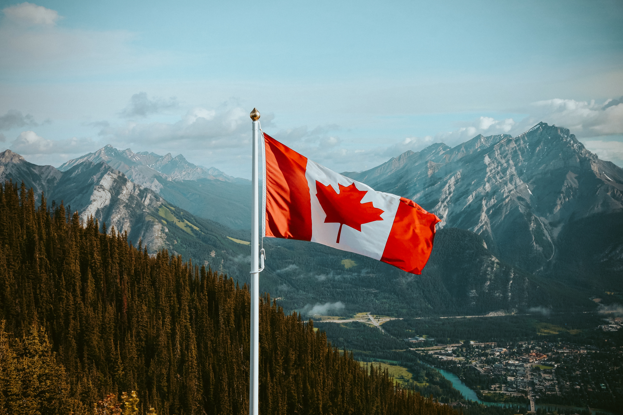 Canadian flag with mountains in the background